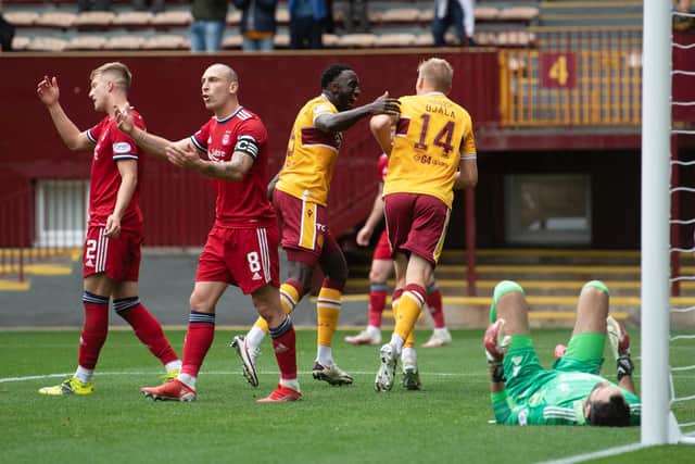 Aberdeen's Scott Brown looks frustrated as Juhani Ojala makes it 2-0 for Motherwell at Fir Park.