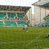 Hibs' Ryan Porteous scores the winner from the penalty spot against Motherwell.