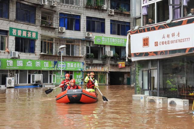 Rescuers evacuate residents after heavy rainfall caused flooding in Quxian county, Dazhou city, in China's northwestern Sichuan province earlier this month (Picture: STR/AFP via Getty Images)