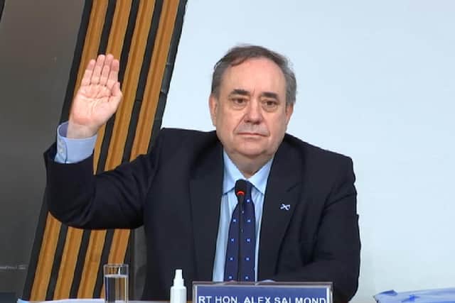 Alex Salmond swears an oath at the Scottish Parliament before giving evidence.
