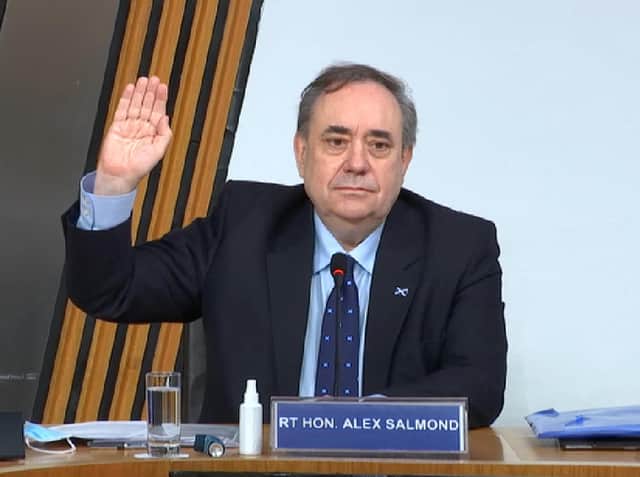 Alex Salmond swears an oath at the Scottish Parliament before giving evidence.