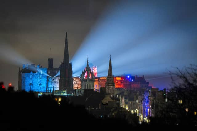 Lights from Edinburgh Castle's 'Castle of Light' event illuminate the city skyline. The tourist sector in Scotland has been badly hit by the emergence of the Omicron variant, with events such as Edinburgh's Hogmanay festivities cancelled. Picture: Jane Barlow/PA Wire