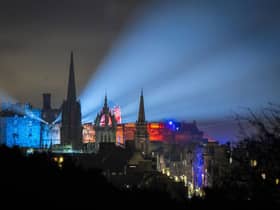 Lights from Edinburgh Castle's 'Castle of Light' event illuminate the city skyline. The tourist sector in Scotland has been badly hit by the emergence of the Omicron variant, with events such as Edinburgh's Hogmanay festivities cancelled. Picture: Jane Barlow/PA Wire
