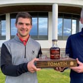 Gleneagles Hotel-attached Tom Higson, left, receives one of his prizes for winning the Tomatin Whisky-sponsored Highland Golf Links Pro Am