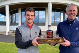 Gleneagles Hotel-attached Tom Higson, left, receives one of his prizes for winning the Tomatin Whisky-sponsored Highland Golf Links Pro Am