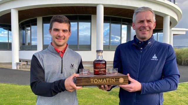 Gleneagles Hotel-attached Tom Higson, left, receives one of his prizes for winning the Tomatin Whisky-sponsored Highland Golf Links Pro Am