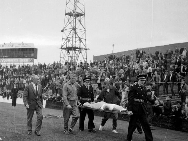 Hibs goalkeeper Willie Wilson is pictured being stretchered off the pitch during a Hibernian v St Mirren game at Easter Road in August 1965.