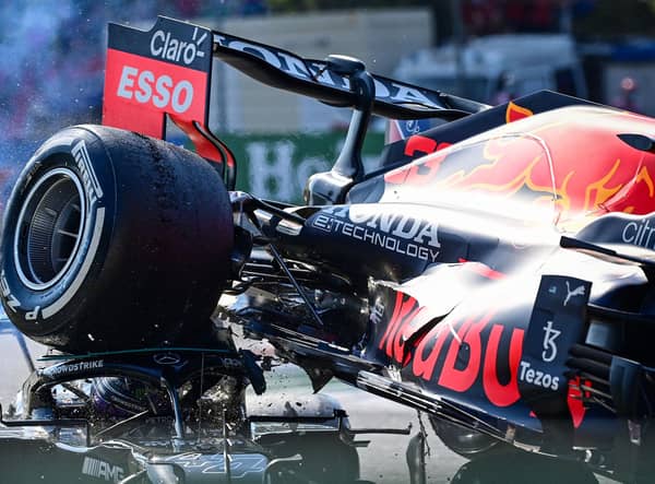 The rear wheel of Max Verstappen's Red Bull Mercedes' collides with the helmet of Lewis Hamilton, with the halo safety feature absorbing most of the impact (Photo by ANDREJ ISAKOVIC/AFP via Getty Images)