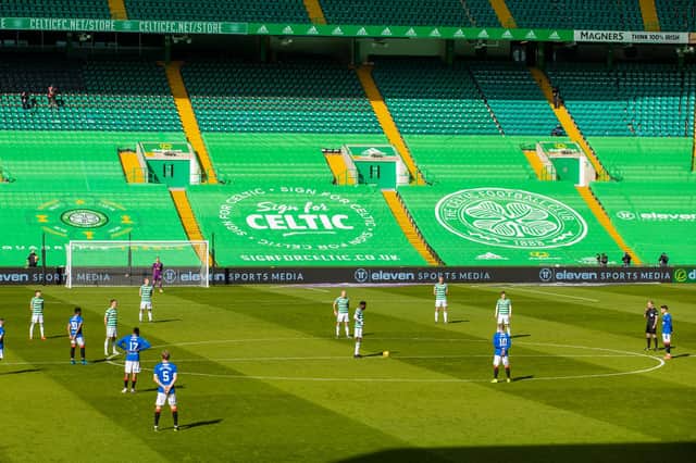 Both sets of players stand together in solidarity against racism ahead of the Scottish Premiership match between Celtic and Rangers at Celtic Park. (Photo by Craig Williamson / SNS Group)