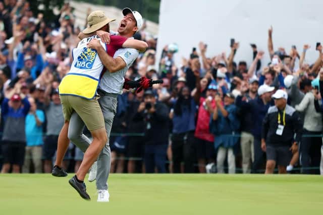 Nick Taylor celebrates with his caddie after rolling in a 72-foot eagle putt on the fourth extra hole to become the first home player to win the RBC Canadian Open since 1954. Picture: Vaughn Ridley/Getty Images.