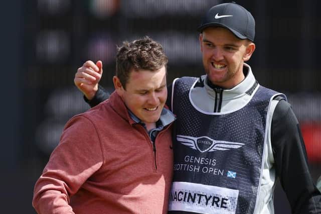 Bob MacIntyre celebrates with his caddie Greg Milne after finshing with a birdie to claim second spot in the Genesis Scottish Open at The Renaissance Club. Picture: Andrew Redington/Getty Images.