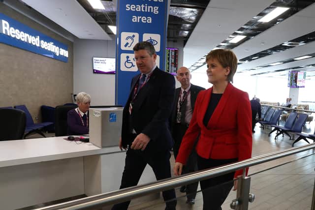 Gordon Dewar accompanying Nicola Sturgeon as she officially opened an Edinburgh Airport terminal expansion in June last year. Picture: Andrew Milligan/PA Wire