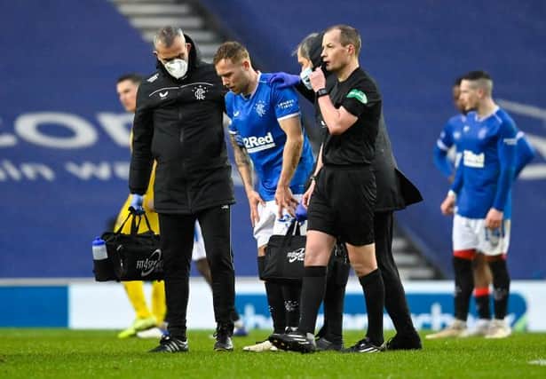 Scott Arfield leaves the field with an injury during the Scottish Premiership match between Rangers and Hibernian at Ibrox on December 26, 2020. (Photo by Rob Casey / SNS Group)