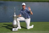 Rory McIlroy poses with the Hero Dubai Desert Classic trophy on the 18th green at Emirates Golf Club after landing a third title triumph in the DP World Tour event. Picture: Warren Little/Getty Images.