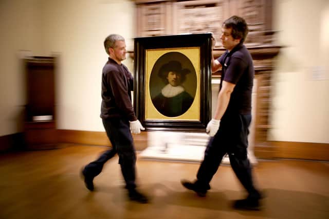 Art technicians Andy Cavanagh (left) and Paul McCall last month moving a painting entitled 'Self Portrait' (1632) by Rembrandt at the Burrell Collection, Glasgow prior to the museum renovation.