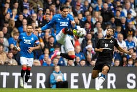 Rangers' Ianis Hagi gets a touch on the ball mid-air to beat Hamburg's Immanuel Pherai.