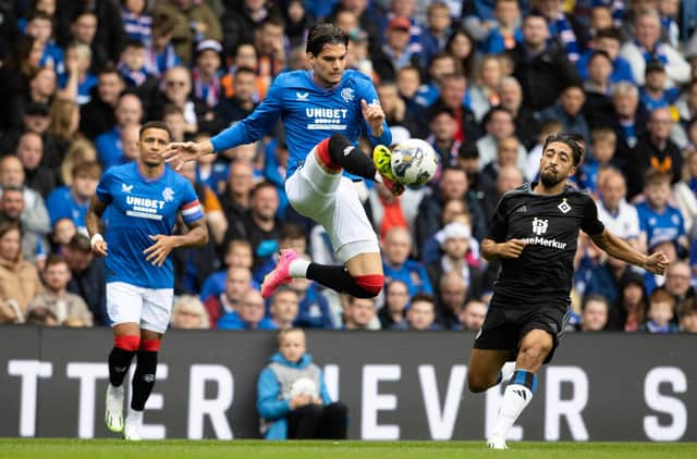 Rangers' Ianis Hagi gets a touch on the ball mid-air to beat Hamburg's Immanuel Pherai.