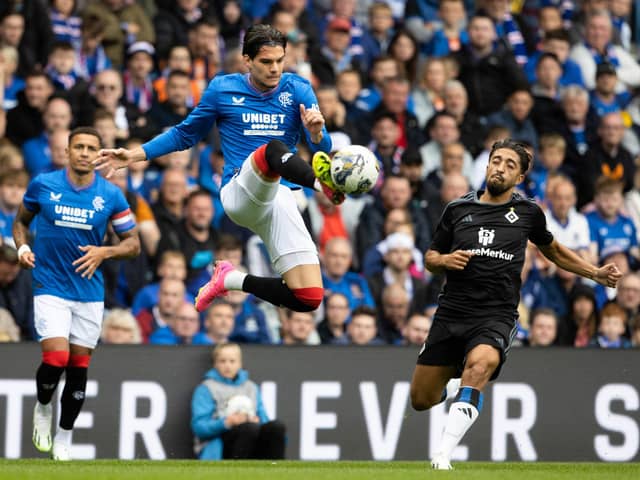 Rangers' Ianis Hagi gets a touch on the ball mid-air to beat Hamburg's Immanuel Pherai.