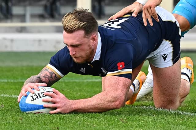 Scotland captain Stuart Hogg grounds the ball over his own line under pressure from Italy centre Federico Mori.