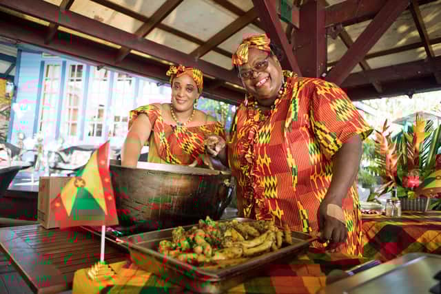 Women serving oil down at the Dodgy Dock, Grenada. Pic: Hannah Stephenson/PA.