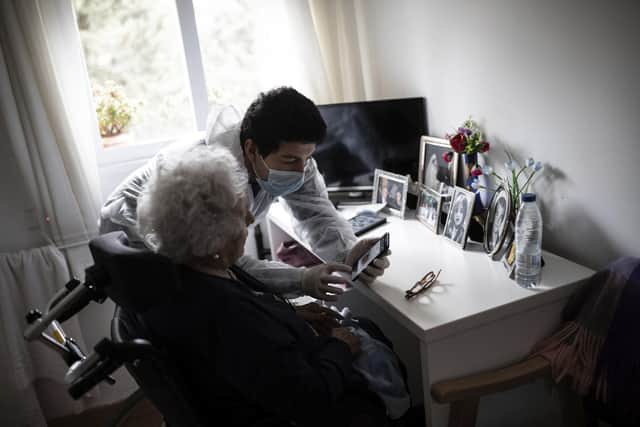 Stock image. A care home worker helps an elder resident  (AP Photo/Bernat Armangue)