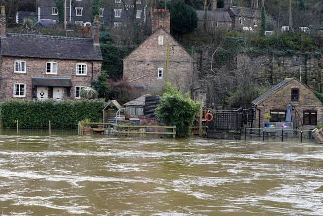 The Vic Haddock boat house (right) is flooded along the swollen River Severn (Pic: Nick Potts/PA Wire)