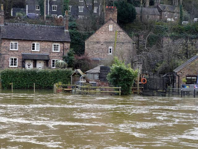 The Vic Haddock boat house (right) is flooded along the swollen River Severn (Pic: Nick Potts/PA Wire)