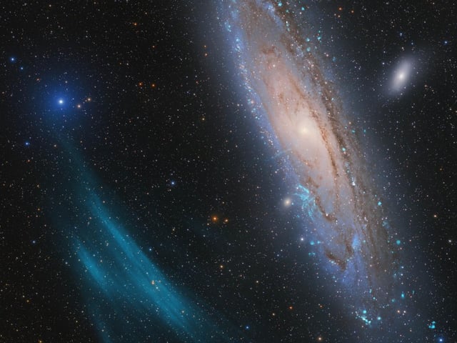 Winner and Overall Winner
Andromeda, Unexpected
A team of amateur astronomers led by Marcel Drechsler, Xavier Strottner and Yann Sainty made a surprising discovery a huge plasma arc next to the Andromeda Galaxy.
Scientists are now investigating the newly discovered giant in a transnational collaboration. It could be the largest such structure in the nearby environment in the Universe.
The Andromeda Galaxy is the closest spiral galaxy to the Milky Way. It is undoubtedly one of the most photographed deep-sky objects ever. The new discovery of such a large structure in the immediate vicinity of the galaxy was all the more surprising.
‘What does a discovery image look like? It is mostly a blurry black and white image that depicts an almost invisible faint dot or a spectrum that is incomprehensible to us. However, that was not the case this time. This astrophoto is as spectacular as it is valuable. It not only presents Andromeda in a new way, but also raises the quality of astrophotography to a new level.’ – László Francsics
Taken with a Takahashi FSQ-106EDX4 telescope, Sky-Watcher EQ6 Pro mount, ZWO ASI2600MM Pro camera, 382 mm f/3.6, multiple exposures between 1 and 600 seconds, 111 hours total exposure
Location: Near Nancy, France