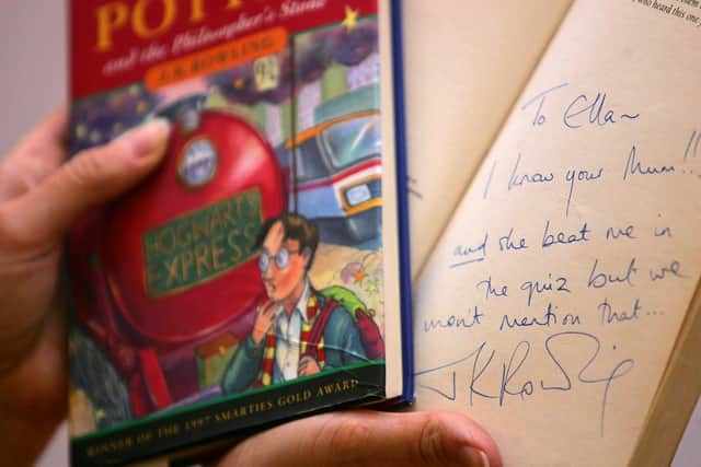 A signed copy of J.K Rowling's Harry Potter and the Philosopher's Stone pictured in Christie's auction house, London. Picture: Cathal McNaughton/PA Wire