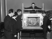 Members of the BBC's children's department watch a demonstration of a model box for the programme Toy Town in 1930 (Picture: Sasha/Hulton Archive/Getty Images)
