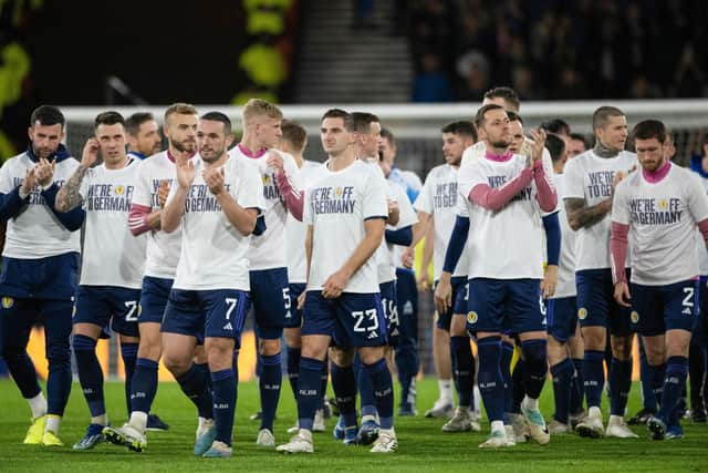 Scotland players wear 'We're off to Germany' tee-shirts during a lap of honour after the 3-3 draw with Norway at Hampden. (Photo by Paul Devlin / SNS Group)