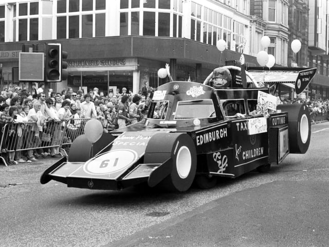 An Edinburgh taxi dressed as a racing car makes its way along Princes Street in the Evening News Festival Cavalcade, August 1983.