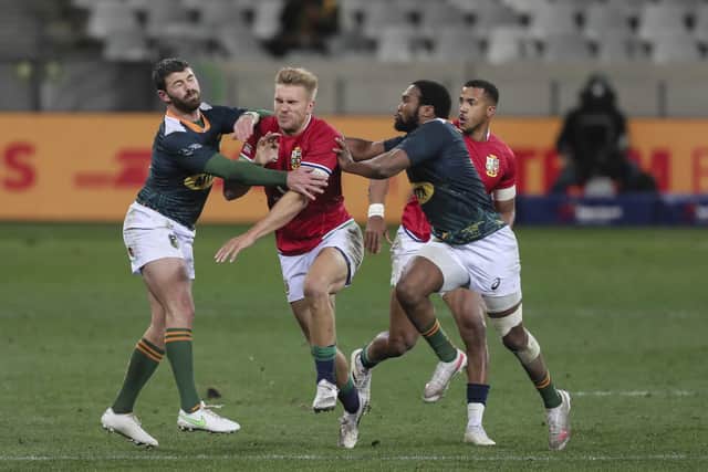 Chris Harris tries to burst through against the South African defence. Picture: Halden Krog/AP
