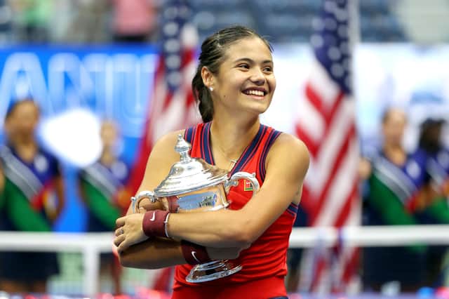 Emma Raducanu celebrates with the championship trophy after defeating Leylah Fernandez in the US Open final. (Photo by Elsa/Getty Images)
