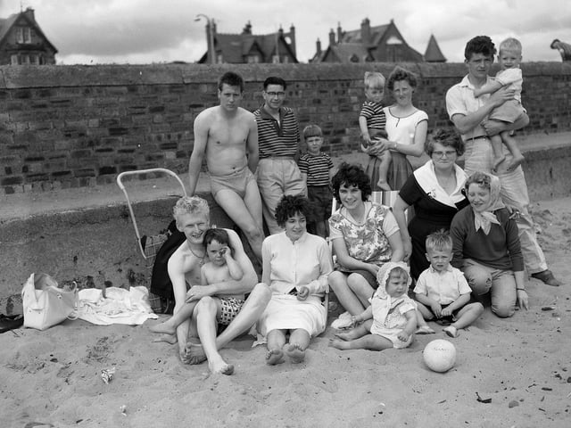 A group of visitors on the beach at Leven, Fife, in summer 1961.