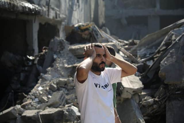 Palestinian citizens inspect damage to their homes caused by Israeli airstrikes in Gaza City, Gaza. At least 1,200 people, including at least 326 children, have been killed and more than 300,000 displaced, after Israel launched sustained retaliatory air strikes after a large-scale attack by Hamas.