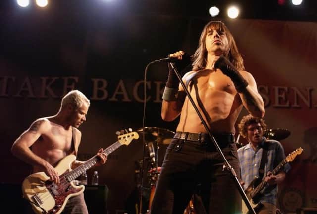 (L-R) Flea, Anthony Kiedis and John Frusciante of The Red Hot Chili Peppers, who have announced a massive outdoor gig in Glasgow next summer. (Photo by Amanda Edwards/Getty Images)