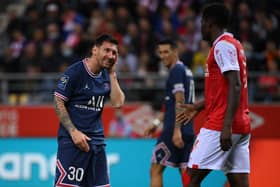 PSG's Argentinian forward Lionel Messi reacts after a challenge from Reims' Zimbabwean midfielder Marshall Munetsi.