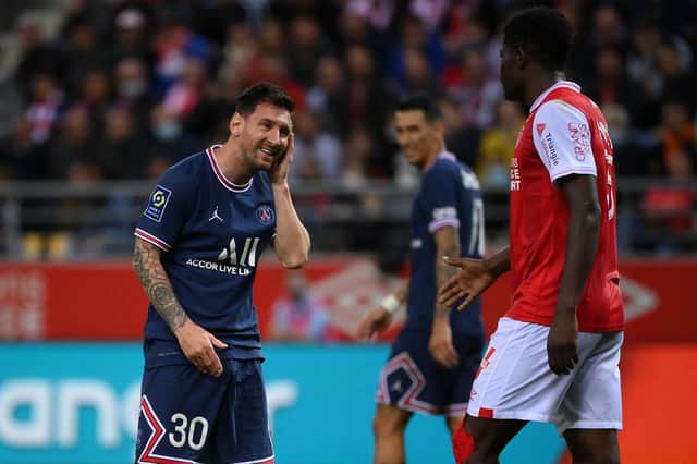 PSG's Argentinian forward Lionel Messi reacts after a challenge from Reims' Zimbabwean midfielder Marshall Munetsi.
