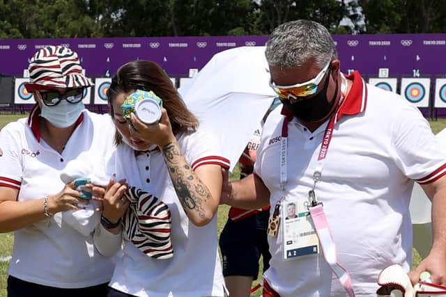 Svetlana Gomboeva of Team ROC is treated for heat exhaustion at Yumenoshima Park Archery Field