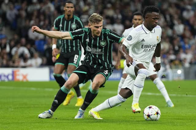 Celtic's Carl Starfelt vies for the ball with Real Madrid's Vinicius Junior during the Champions League match at the Bernabeu. (AP Photo/Manu Fernandez)