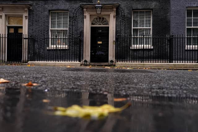 Rain and fallen leaves create an autumn atmosphere at 10 Downing Street in London. Picture: AP Photo/Alberto Pezzali