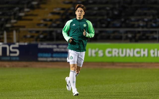 Celtic defender Yuki Kobayashi warms up ahead of taking part in Cammy Kerr's Dundee testimonial match at Dens Park. (Photo by Ross Parker / SNS Group)