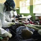 A health worker attends to a Covid patient at Queen Elizabeth Central Hospital in Blantyre, Malawi, after a resurgence of the virus (Picture: Thoko Chikondi/AP)