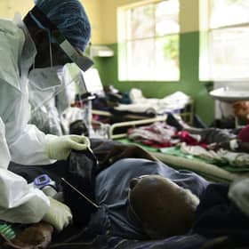 A health worker attends to a Covid patient at Queen Elizabeth Central Hospital in Blantyre, Malawi, after a resurgence of the virus (Picture: Thoko Chikondi/AP)