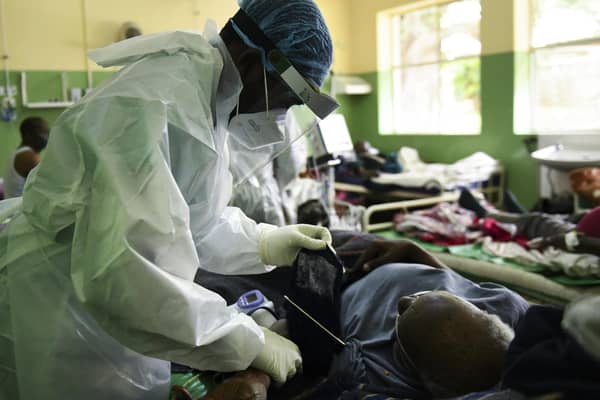 A health worker attends to a Covid patient at Queen Elizabeth Central Hospital in Blantyre, Malawi, after a resurgence of the virus (Picture: Thoko Chikondi/AP)