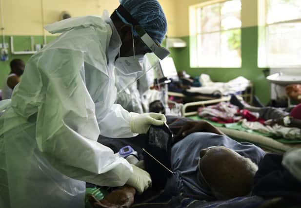A health worker attends to a Covid patient at Queen Elizabeth Central Hospital in Blantyre, Malawi, after a resurgence of the virus (Picture: Thoko Chikondi/AP)