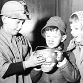 Edinburgh guisers warm their hands over their turnip lantern in 1956. Picture: TSPL