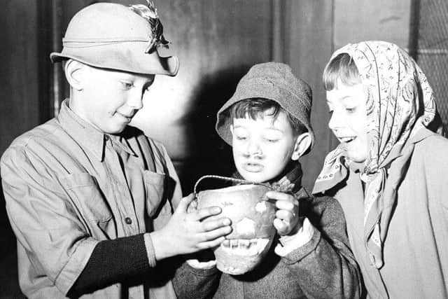 Edinburgh guisers warm their hands over their turnip lantern in 1956. Picture: TSPL