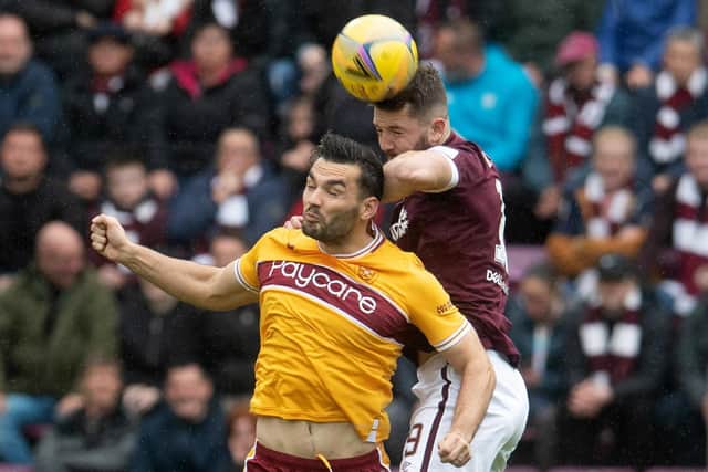 The aerially dominant Craig Halkett climbs over Tony Watt during a match between Hearts and Motherwell at Tynecastle. Picture: SNS